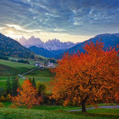 Noel Baba Magdalena 'nın sonbahar şafağı ünlü İtalyan Dolomites köy manzarası Geisler veya Odle Dolomites Grubu dağ kayaları önünde. Resimli seyahat ve kırsal güzellik kavramı.