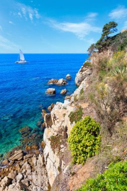 Çiçek açması yaz deniz kayalık sahil peyzaj, Costa Brava, İspanya. Katamaran tanınmayan insanlar.