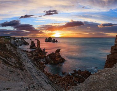 Sunset Atlantic ocean rocky coastline near Portio Beach (Pielagos, Cantabria, Spain). clipart