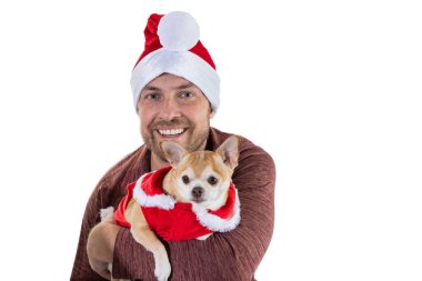 Beyaz bir arka planda izole edilmiş Noel şapkası ve elbisesi olan bir adam ve köpek yavrusu.