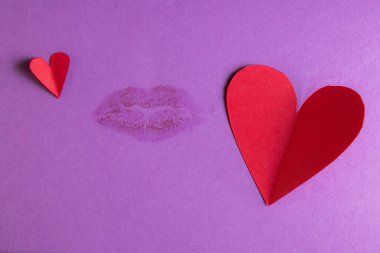 concept for a love note with hand cut hearts and a kiss