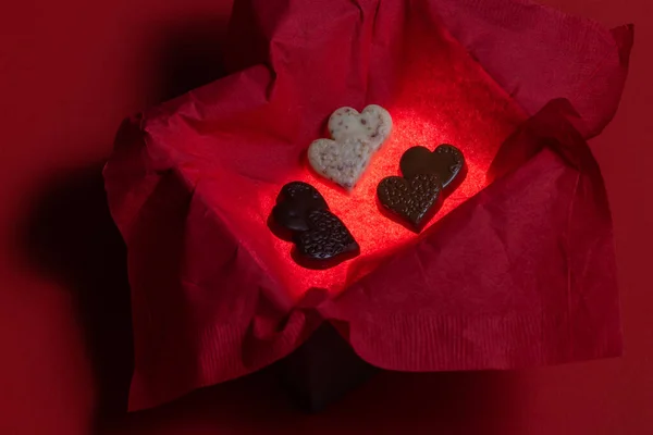 Heart Shaped Chocolates Glowing Box Red Background — Foto de Stock