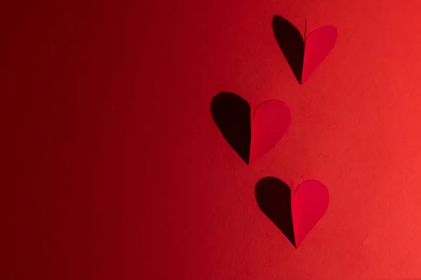Heart Cut Out Casting Shadow Red Background Using Direct Light — Stock fotografie