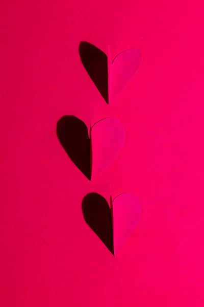 Heart Cut Out Casting Shadow Red Background Using Direct Light — Stok fotoğraf