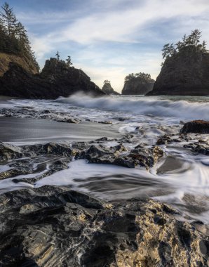 Beautiful Secret Beach in the Samuel H Boardman Scenic Corridor along the Oregon Coast at sunset with a faint glow on the rocks