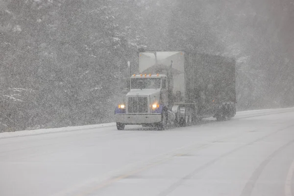 Large Truck driving on snow covered highway 101 in Southern Oregon, February 2023