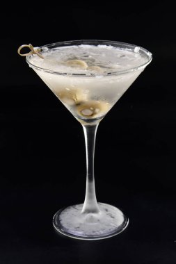 Soğuk votka martini, siyah arka planda izole edilmiş peynirli zeytin dolması.