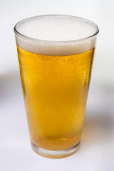 Glass Beer Sitting White Background Glass Half Full Beer Foamy — Stock Photo, Image