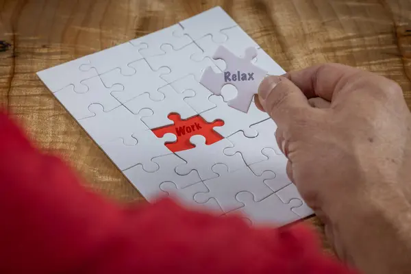 Blank puzzle with the missing piece being held next to the whole with a red placer where the last piece belongs. Concept for problem solving.