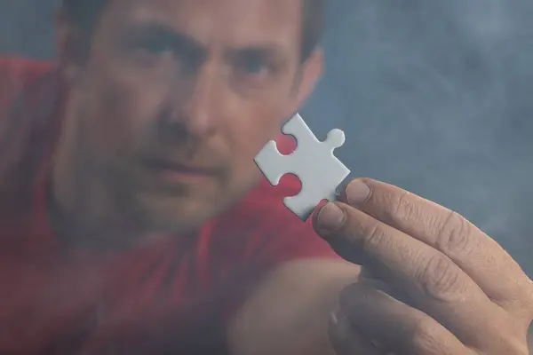 Man Holding White Puzzle Piece His Hand Concept Curiosity Desire 图库照片