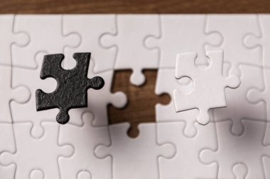 Siyah arkaplanda beyaz ve siyah yapboz parçaları kullanarak karşıt gün kavramı.