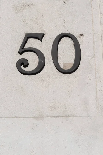 Nummer Dunklen Figuren Weißer Steinmauer — Stockfoto