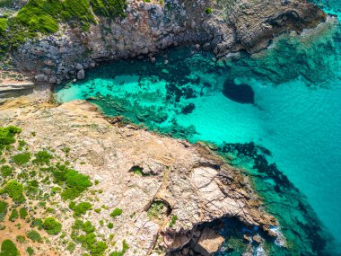 Areal drone view of beautiful bay and Arenal d'en Castell beach on Menorca island, Spain clipart