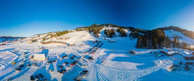 The Neusell ski area and village in winter, Rothenthurm, Biberegg - Canton of Schwyz, Switzerland clipart