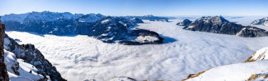 Aerial drone view of snow covered mountains and ski slopes, ski area Stoos,Switzerland clipart