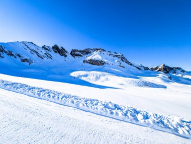 Ski slopes and mountains, Melchsee-Frutt mountain resort village, Switzerland in winter clipart