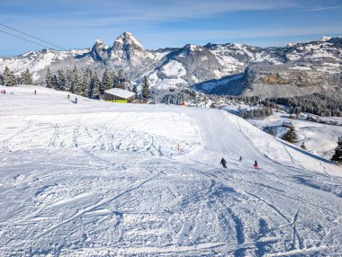 Aerial drone view of snow covered mountains and ski slopes, ski area Stoos,Switzerland clipart