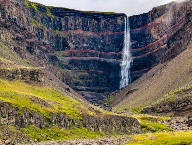 Aerial drone view of Hengifoss waterfall landscape in Iceland. Red layers of clay between basaltic layers. clipart