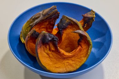 slices of baked pumpkin in a bowl