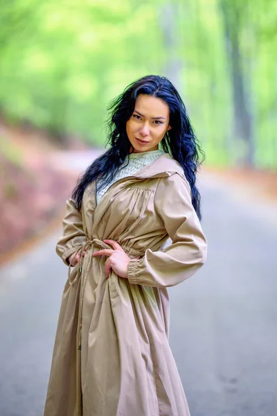 在树林中的路上的一个黑发女人的画像 — 图库照片