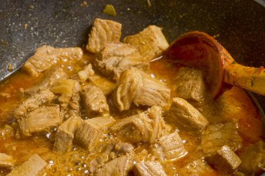 Domuz eti, yemek pişirmek için bir tavada parçalara ayrıldı.