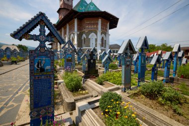 Sapanta Romania July 14, 2024. The Vesel Cemetery is a cemetery in Sapanta Maramures County, famous for its brightly colored grave crosses and naive paintings representing scenes from life. clipart
