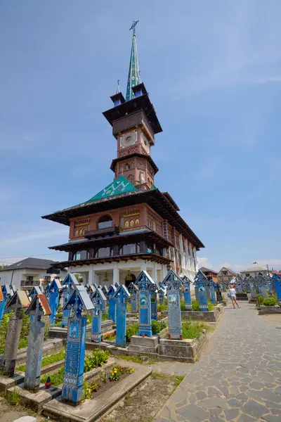 stock image Sapanta Romania July 14, 2024. The Vesel Cemetery is a cemetery in Sapanta Maramures County, famous for its brightly colored grave crosses and naive paintings representing scenes from life.