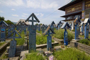 Sapanta Romania July 14, 2024. The Vesel Cemetery is a cemetery in Sapanta Maramures County, famous for its brightly colored grave crosses and naive paintings representing scenes from life. clipart