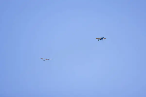 stock image a small plane towing a glider for training.