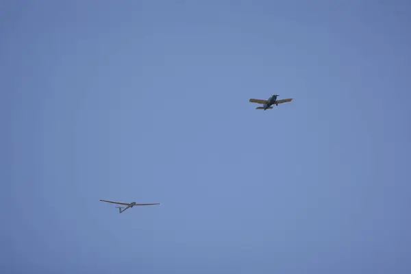 Stock image a small plane towing a glider for training.