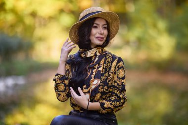 Güz boyunca güzel bir kadın gölün kenarında bir kütükte oturur.