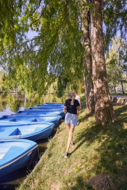 İki orta yaşlı kız kardeş bir yaz sabahını parkta dinlenerek ve eğlenerek geçiriyorlar..