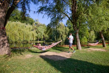 Baba ve kızı parkta birlikte zaman geçiriyorlar. Egzersiz yapıyor ve dinleniyorlar..