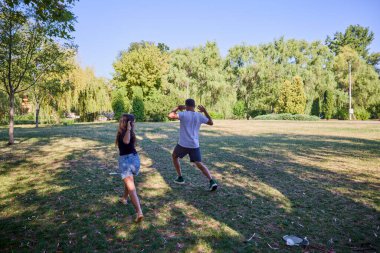 Baba ve kızı parkta birlikte zaman geçiriyorlar. Egzersiz yapıyor ve dinleniyorlar..
