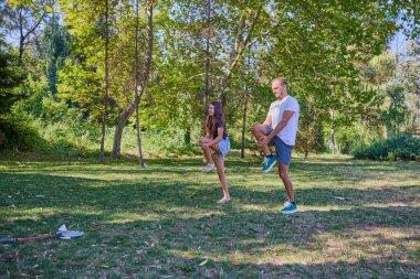 Baba ve kızı parkta birlikte zaman geçiriyorlar. Egzersiz yapıyor ve dinleniyorlar..