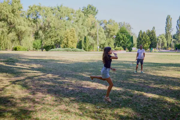 Baba ve kızı parkta birlikte zaman geçiriyorlar. Egzersiz yapıyor ve dinleniyorlar..