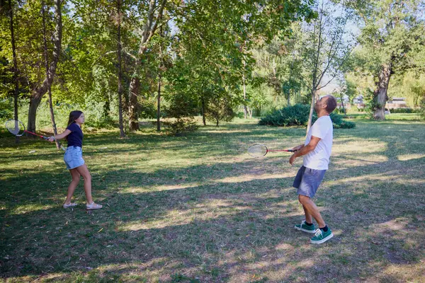Baba ve kızı parkta birlikte zaman geçiriyorlar. Egzersiz yapıyor ve dinleniyorlar..