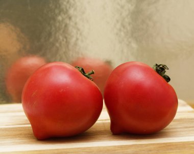 Round Pink tomato with a nose that produces heart shape when cut in half clipart
