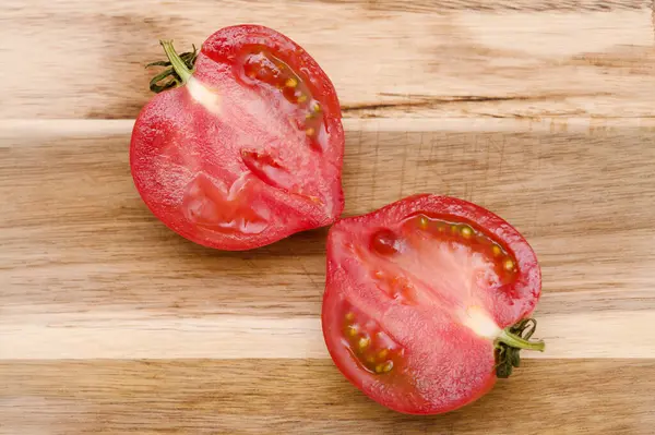 Round Pink tomato with a nose that produces heart shape when cut in half