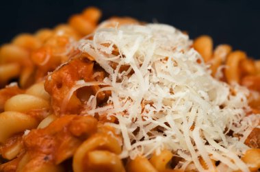 Fusilli pasta with tuna  and tomato sauce with grated Grana Padano cheese clipart