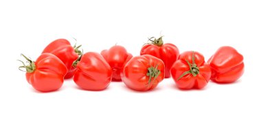 Small bright red deeply ribbed tomatoes isolated on White background clipart