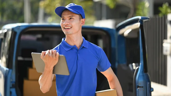 Delivery service courier with digital tablet and parcel box in hand. Shipping and delivery service concept.