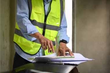 Cropped shot of engineer manager inspecting industrial building construction site. Industry, Engineer, construction concept.