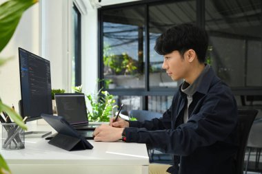 Coding programmer working on software development on desktop computer at modern office.