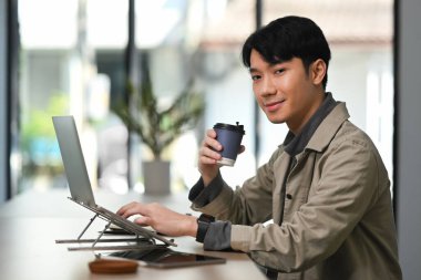 Young start up businessman analyzing statistics or commerce data on laptop computer.