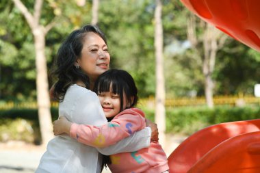 Affectionate grandmother cuddling her sweet lovely granddaughter. Loving family relationship concept.