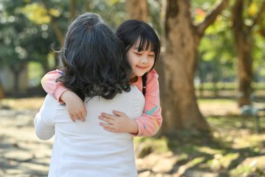 Affectionate grandmother cuddlingsweet lovely granddaughter. Loving family relationship concept.
