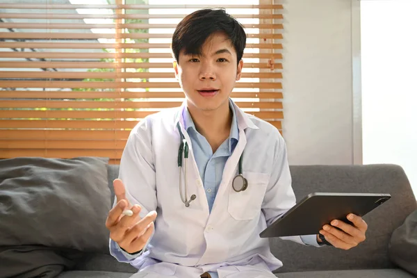 Head shot of doctor in white uniform with stethoscope remote online medical chat consultation, talking online with patient.