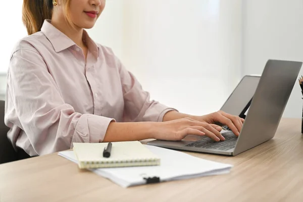 Cropped shot of young woman financial advisor answering or giving consultation to customer on laptop computer.