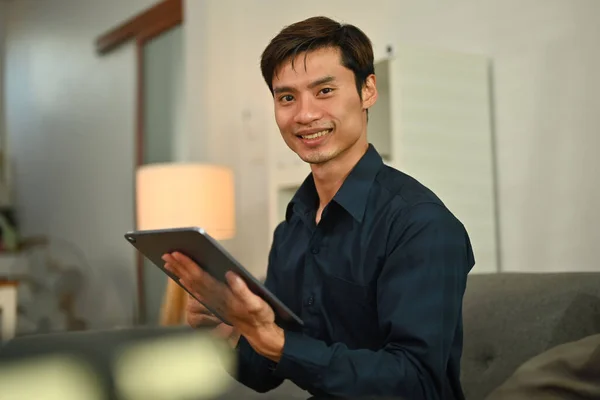 Smiling Asian Man Using Digital Tablet Reading Ebook App Online — Fotografia de Stock